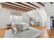 Bedroom with exposed wooden beams, hardwood floors, and a window at 212 Calhoun, Charleston, SC 29401