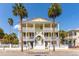 Three-story yellow house with white columns and balconies at 212 Calhoun, Charleston, SC 29401