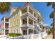 Three-story yellow house with white columns, balconies, and fenced yard at 212 Calhoun, Charleston, SC 29401