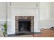 Brick fireplace with white mantel in a living room at 212 Calhoun, Charleston, SC 29401