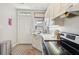 White kitchen with stainless steel appliances and exterior access at 212 Calhoun, Charleston, SC 29401