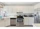 Kitchen with white cabinets, stainless steel appliances, and patterned flooring at 212 Calhoun, Charleston, SC 29401