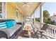 Spacious porch with wicker seating and city views at 212 Calhoun, Charleston, SC 29401