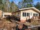 Tan house with ramp access, wooden steps, and detached shed at 218 Cat Hole Ln, Branchville, SC 29432