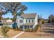 Aerial view of a two-story light blue house and surrounding neighborhood at 2202 St Johns Woods Pkwy, Johns Island, SC 29455