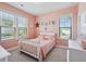 Charming bedroom with pink walls, a white crib, and plenty of natural light at 2202 St Johns Woods Pkwy, Johns Island, SC 29455