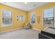 Bedroom with yellow walls, neutral decor, and lots of natural light at 2202 St Johns Woods Pkwy, Johns Island, SC 29455