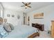 Bright bedroom with wood platform bed and ceiling fan at 2202 St Johns Woods Pkwy, Johns Island, SC 29455