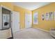Bright bedroom with yellow walls, double doors, and a view of another room at 2202 St Johns Woods Pkwy, Johns Island, SC 29455