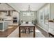 Dining room with a rustic table, chandelier, and large windows at 2202 St Johns Woods Pkwy, Johns Island, SC 29455