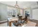 Bright dining room features a rustic wooden table with four chairs and a chandelier at 2202 St Johns Woods Pkwy, Johns Island, SC 29455