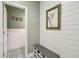 Inviting entry with built-in bench, shiplap walls, and access to powder room at 2202 St Johns Woods Pkwy, Johns Island, SC 29455