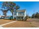Two-story light blue house with a front porch and landscaped yard at 2202 St Johns Woods Pkwy, Johns Island, SC 29455