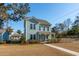 Two-story light blue house with a front porch and landscaped yard at 2202 St Johns Woods Pkwy, Johns Island, SC 29455
