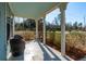 Relaxing front porch with wicker chairs and view of the neighborhood at 2202 St Johns Woods Pkwy, Johns Island, SC 29455