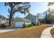 Light blue house with detached garage and manicured lawn at 2202 St Johns Woods Pkwy, Johns Island, SC 29455