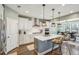 Open concept kitchen with island, white cabinets, and stainless steel appliances at 2202 St Johns Woods Pkwy, Johns Island, SC 29455
