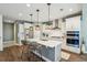 Modern kitchen with white cabinets, quartz countertops, and stainless steel appliances at 2202 St Johns Woods Pkwy, Johns Island, SC 29455