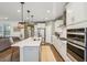Open concept kitchen with island, white cabinets and stainless steel appliances at 2202 St Johns Woods Pkwy, Johns Island, SC 29455