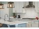 White kitchen cabinets, quartz countertops, and a stainless steel range hood at 2202 St Johns Woods Pkwy, Johns Island, SC 29455