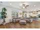 Open concept living room with L-shaped sectional sofa and kitchen view at 2202 St Johns Woods Pkwy, Johns Island, SC 29455