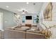 Living room with L-shaped sectional sofa, wood floors, and shiplap wall at 2202 St Johns Woods Pkwy, Johns Island, SC 29455