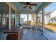 Screened porch with ceiling fan, outdoor seating, and a view of the backyard at 2202 St Johns Woods Pkwy, Johns Island, SC 29455