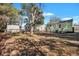 Large backyard with mature trees and a view of neighboring houses at 2268 Bailey Dr, North Charleston, SC 29405
