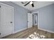 Bedroom with hardwood floors, two doors, and a ceiling fan at 2268 Bailey Dr, North Charleston, SC 29405