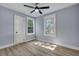 Bright bedroom with hardwood floors, ceiling fan, and two windows at 2268 Bailey Dr, North Charleston, SC 29405