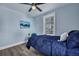 Blue bedroom with a double bed, a chair and large window at 2268 Bailey Dr, North Charleston, SC 29405