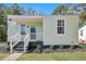 Renovated light green house with a porch and landscaping at 2268 Bailey Dr, North Charleston, SC 29405