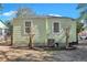 Side view of light green house, showcasing windows and AC unit at 2268 Bailey Dr, North Charleston, SC 29405
