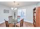 Dining room with glass table, four chairs, and built-in shelving at 2311 Tall Sail Dr # B, Charleston, SC 29414