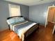 Bright bedroom featuring a queen-size bed and hardwood floors at 235 Blossom St, Goose Creek, SC 29445