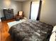 Bedroom with king-size bed, sitting area, and hardwood floors at 235 Blossom St, Goose Creek, SC 29445
