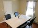 Modern dining room with marble table, four black chairs, and hardwood floors at 235 Blossom St, Goose Creek, SC 29445