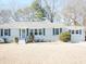 Ranch style home with gray exterior, landscaping, and a spacious lawn at 235 Blossom St, Goose Creek, SC 29445