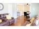 Open living room with hardwood floors, leather recliners, and view of dining area at 235 Blossom St, Goose Creek, SC 29445
