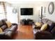 Spacious living room with hardwood floors, large TV, and comfortable seating at 235 Blossom St, Goose Creek, SC 29445