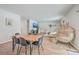 Dining area with wood table and black chairs, open to the living room at 261 Firewheel Ct, Summerville, SC 29486
