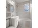 Bathroom featuring new vanity, shower, and tiled wall with floral accent window at 2889 Alabama Drive, North Charleston, SC 29405