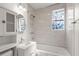 Bathroom featuring new vanity, shower, and tiled wall with floral accent window at 2889 Alabama Drive, North Charleston, SC 29405