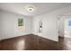 A well-lit bedroom with gleaming dark floors, a modern light and connections to other rooms at 2889 Alabama Drive, North Charleston, SC 29405