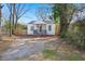 Charming exterior showcasing a quaint home with a welcoming front porch and gravel driveway at 2889 Alabama Drive, North Charleston, SC 29405