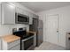 Modern kitchen featuring gray cabinetry, stainless steel appliances, butcher block countertops, and marble floors at 2889 Alabama Drive, North Charleston, SC 29405