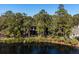 Aerial view showcasing the property's waterfront location and wooded surroundings at 2908 Old Drake Dr, Seabrook Island, SC 29455