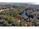 Aerial view of house nestled in trees near water, ocean in distance at 2908 Old Drake Dr, Seabrook Island, SC 29455