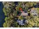 Aerial view of the home nestled in a wooded area adjacent to a tranquil lake at 2908 Old Drake Dr, Seabrook Island, SC 29455