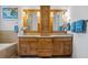 Double vanity bathroom with wood cabinets and large mirrors at 2908 Old Drake Dr, Seabrook Island, SC 29455